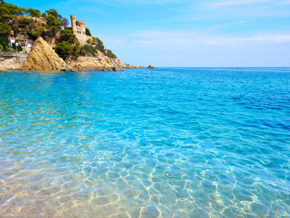 Sa Caleta beach and homes near the sea in Lloret de Mar